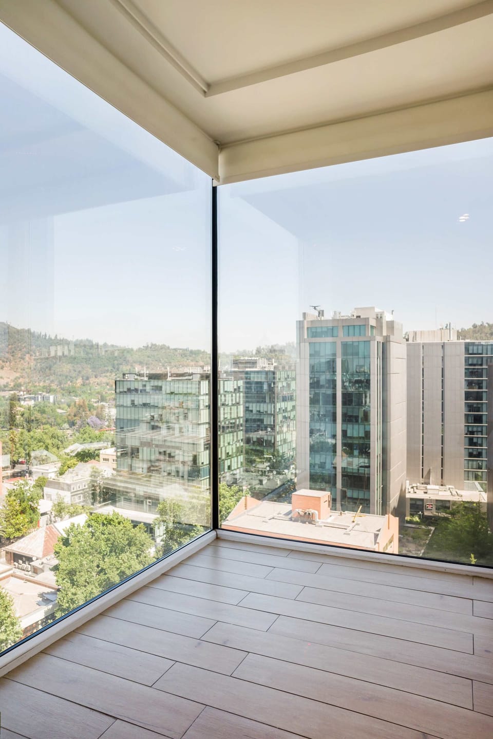 Experience stunning city and mountain views through expansive floor-to-ceiling windows in this bright, modern space.