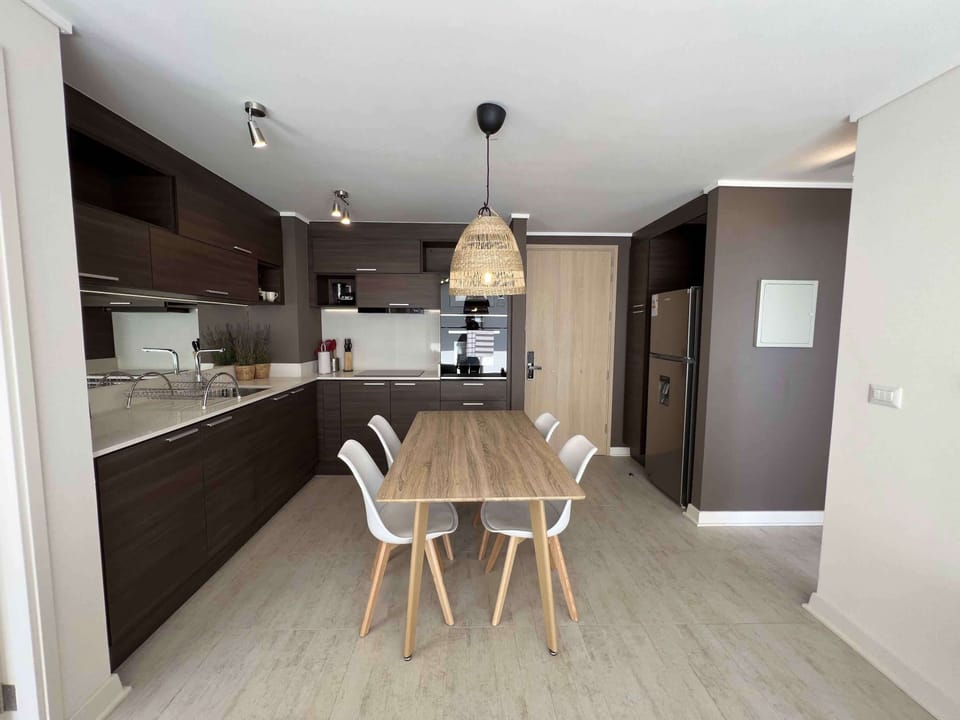 Sleek kitchen with integrated dining area, perfect for cozy meals and gatherings.