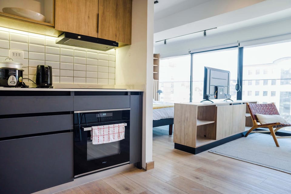 Experience modern living in this stylish studio with a sleek kitchen and bright open layout, perfect for a cozy stay.