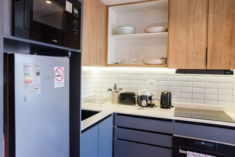 Modern and fully-equipped kitchen with sleek appliances and stylish cabinetry, perfect for cooking your favorite meals.