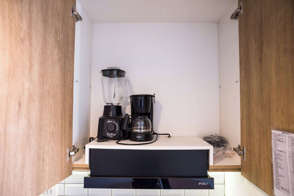 Convenient kitchen appliances ready for your culinary needs in this cozy studio apartment.