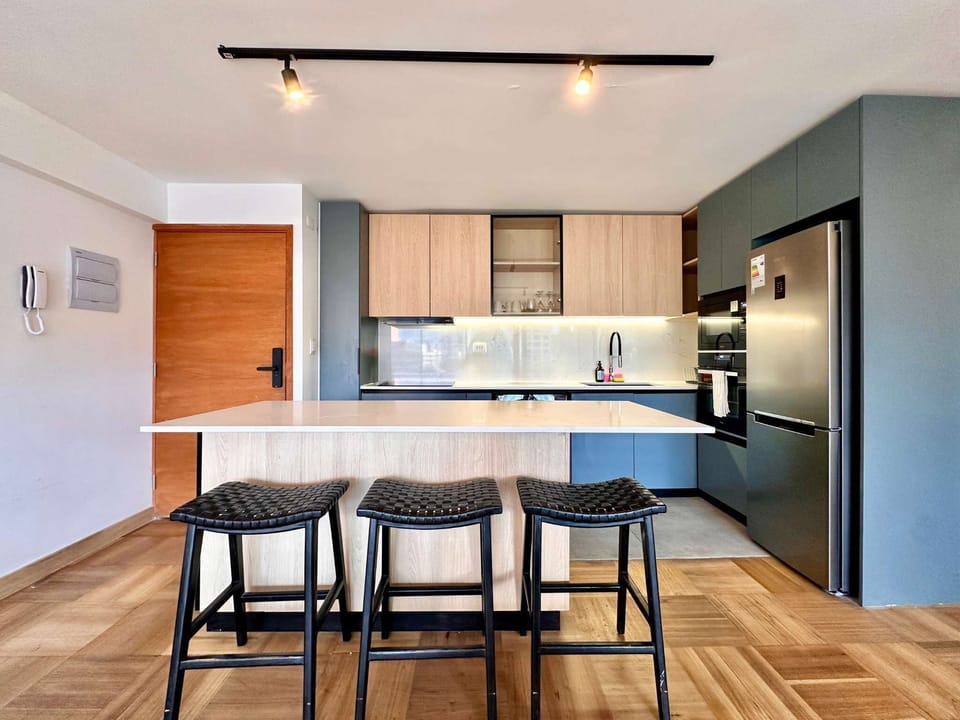 Sleek and modern kitchen with a spacious island, perfect for cooking and dining in style.