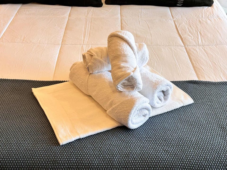 Experience comfort with plush linens and fresh towels in this cozy retreat, perfect for a relaxing stay.