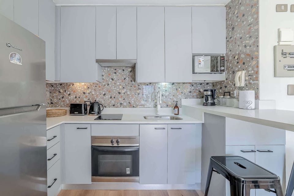 Sleek and modern kitchen with terrazzo accents, perfect for cooking and enjoying meals in style.