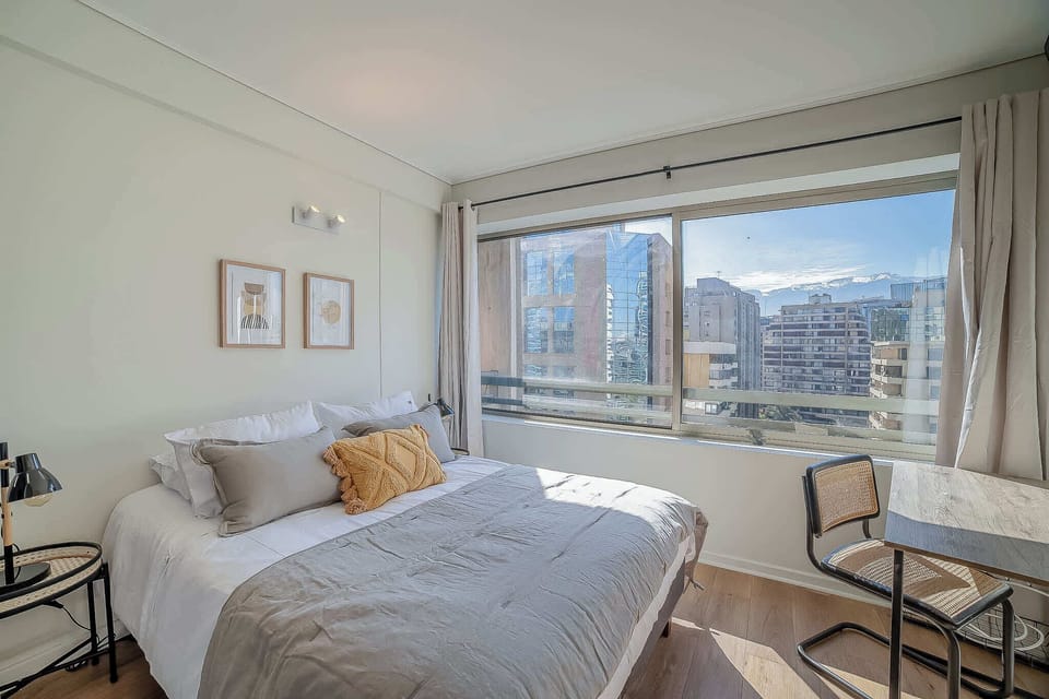 Relax in this cozy bedroom with stunning city views, perfect for unwinding after a day of exploring.