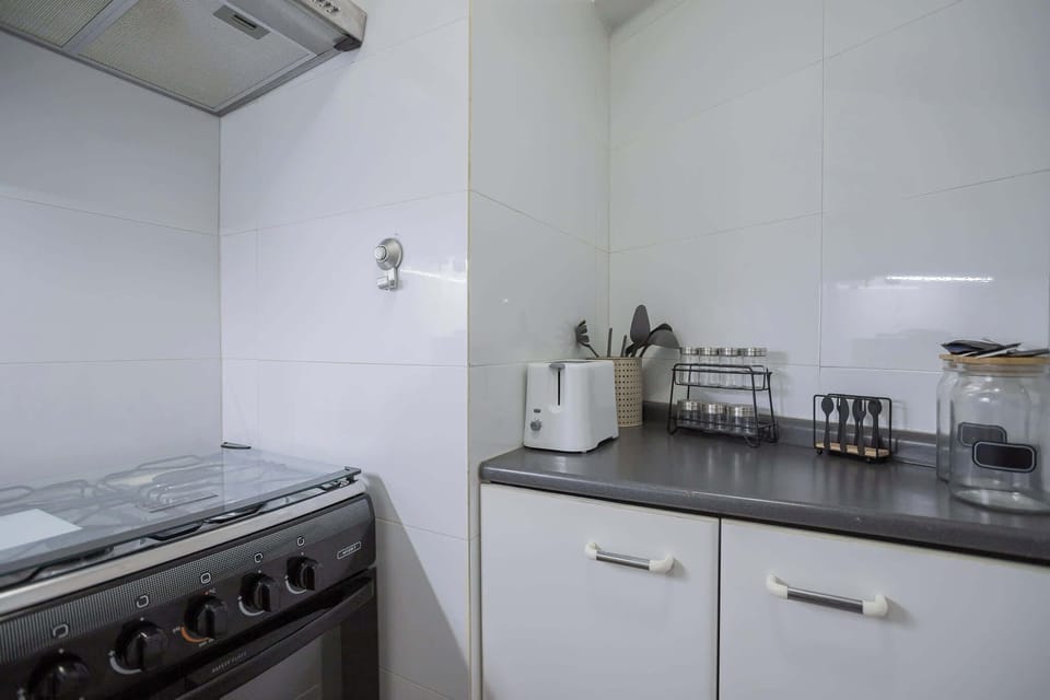 Compact and well-equipped kitchen with modern appliances, perfect for preparing meals during your stay.