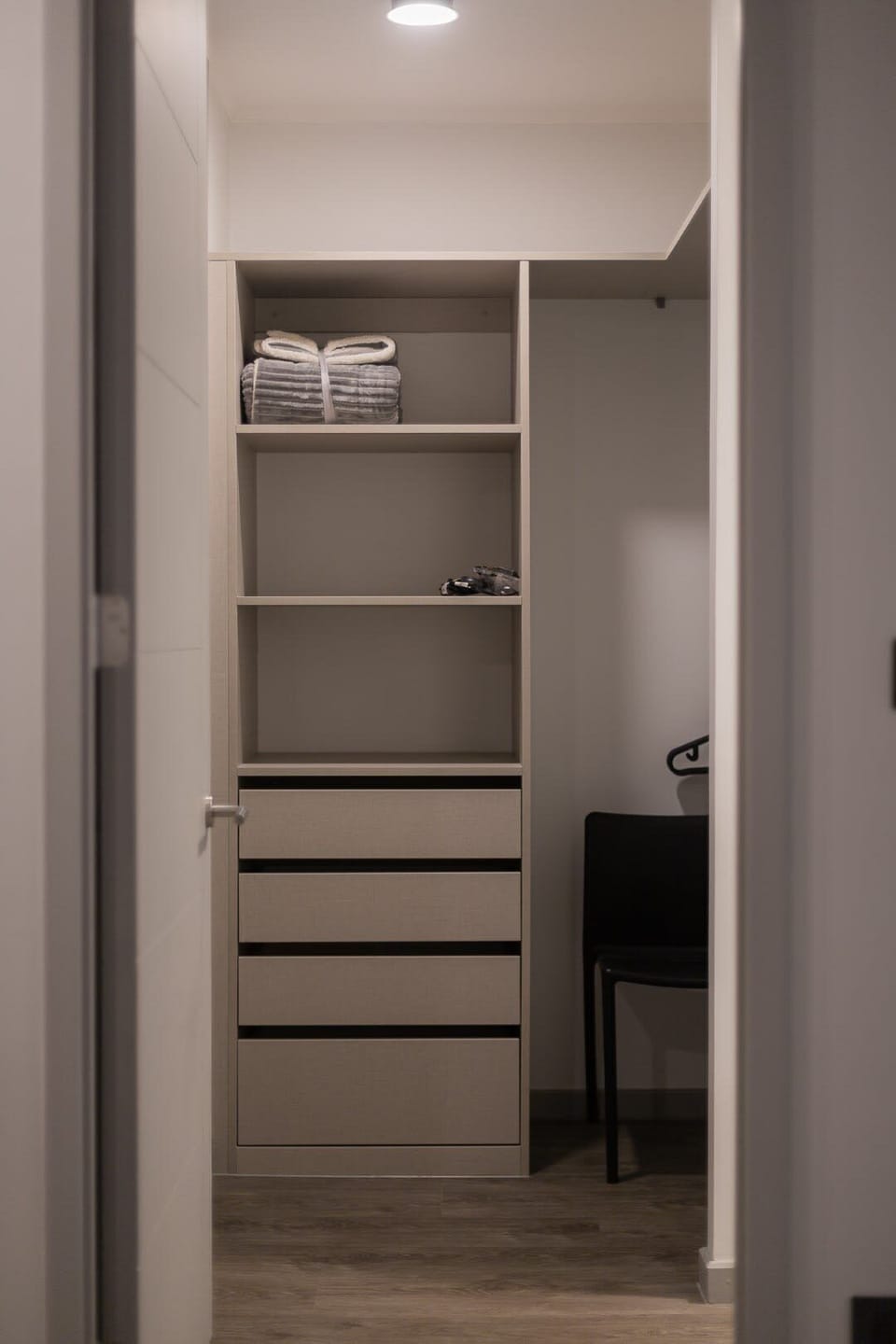 Spacious closet with ample storage and cozy lighting for a comfortable stay.