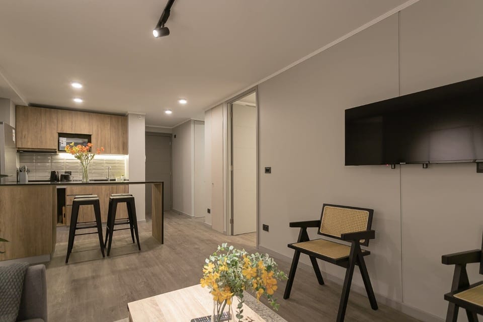 Sleek and modern living space with open kitchen, perfect for relaxing or entertaining guests.