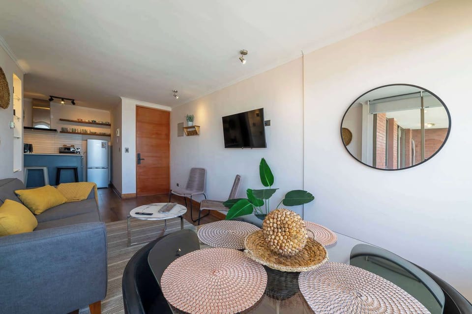 Chic and cozy living space with modern amenities, perfect for relaxing after a day exploring the vibrant city of Santiago.