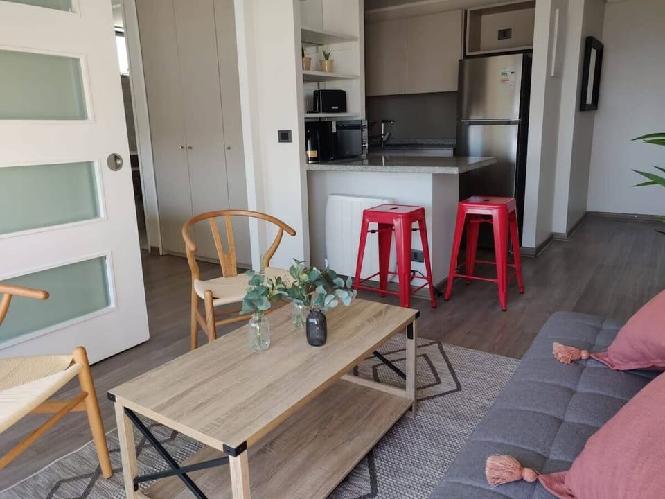 Cozy living area with modern kitchen and stylish decor, perfect for relaxing after a day of exploring.