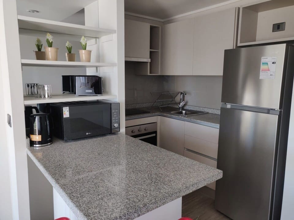 Modern kitchen with sleek appliances and ample counter space, perfect for family meals.
