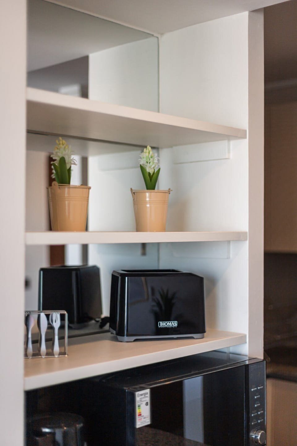 Compact and functional kitchen with modern appliances and stylish decor, perfect for a cozy stay.