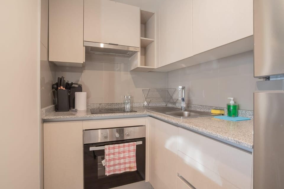 Modern kitchen with sleek design and ample counter space, perfect for preparing meals during your stay.