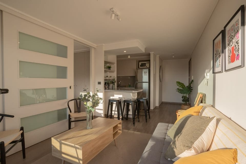 Cozy and bright living space with modern decor and a fully equipped kitchen, perfect for relaxation and dining.