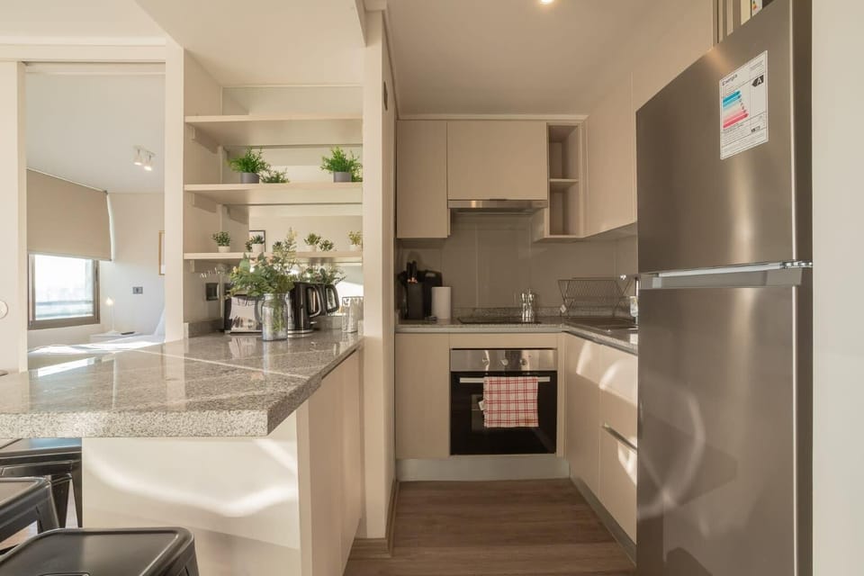Sleek and modern kitchen with stainless steel appliances and granite countertops, perfect for cooking and entertaining.