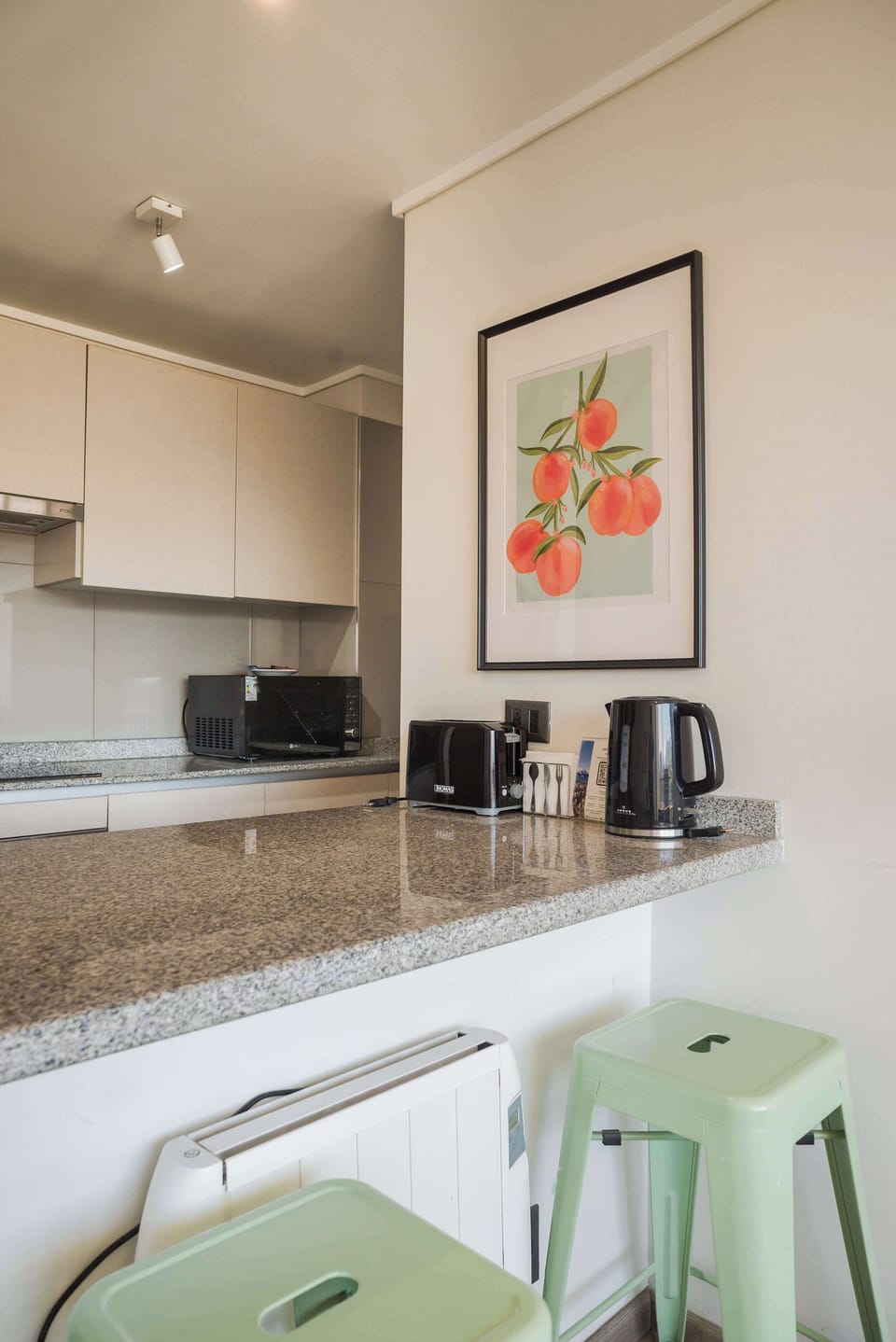 Cozy kitchen nook with modern appliances and stylish seating, perfect for a quick meal or morning coffee.