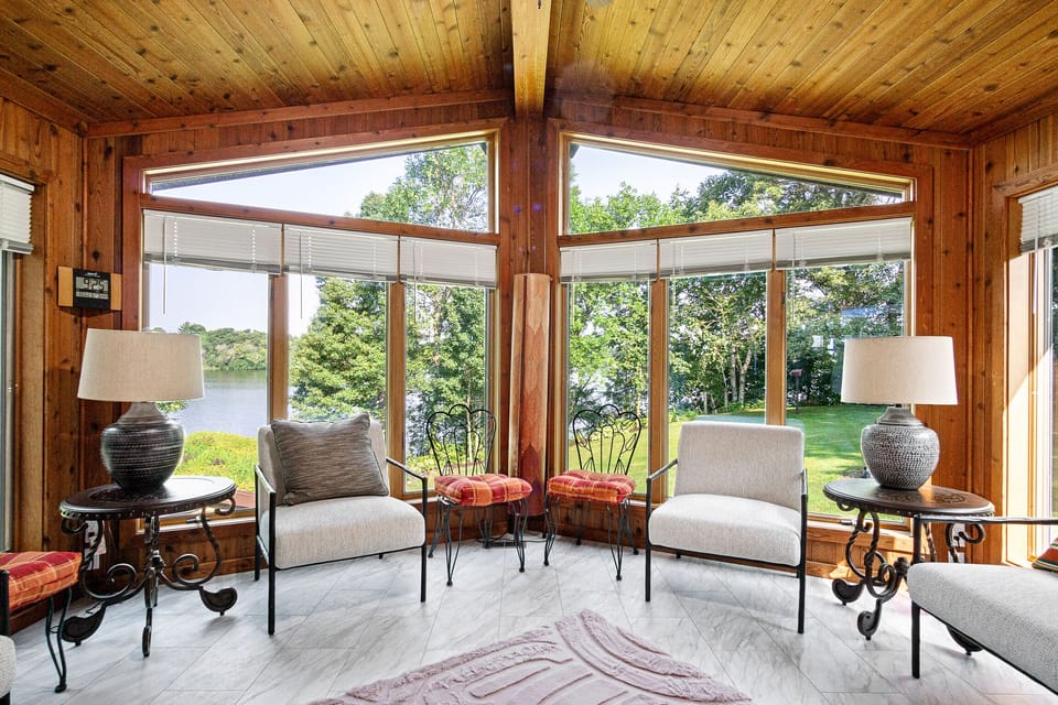 The sunroom off of the dining room/kitchen with stunning views of Lake Wissota.