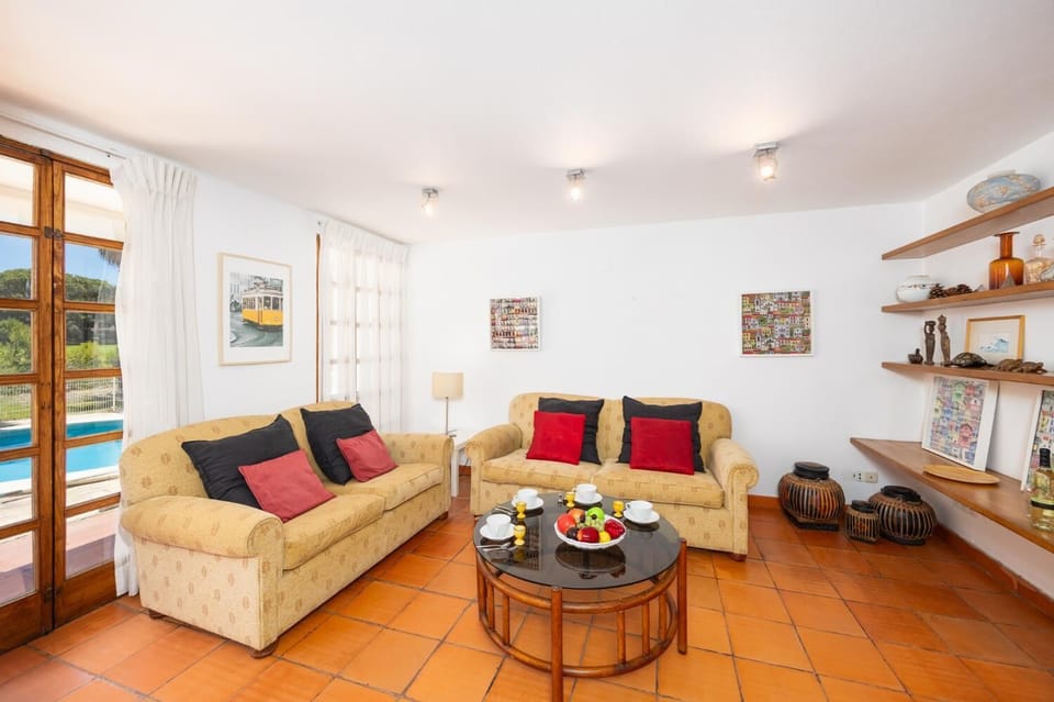 Open-plan living room with sofas, dining area, kitchen, ornamental fireplace, WiFi internet, and satellite TV