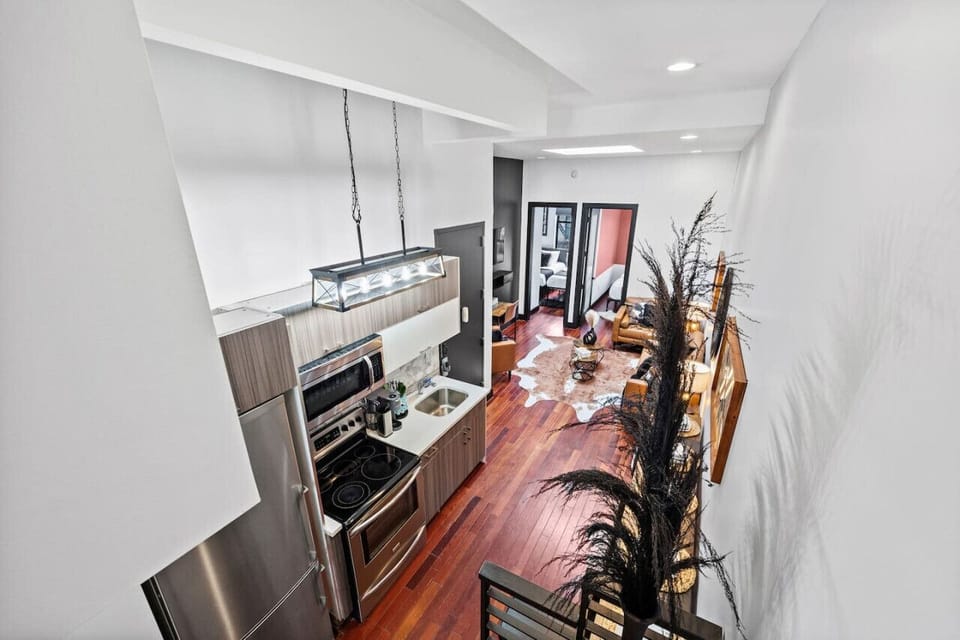 Warm wood cabinetry and hardwood floors bring natural elegance, creating a space that's both sophisticated and welcoming.