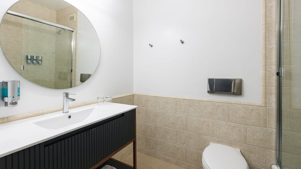 Refresh in a bright, modern bath with walk-in shower.