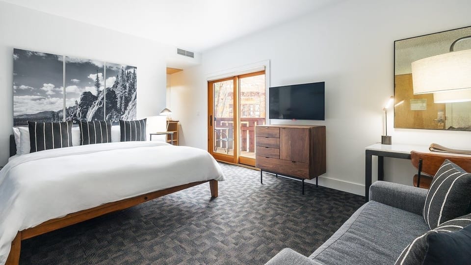 Unwind in a spacious bedroom with balcony and lounge chair.