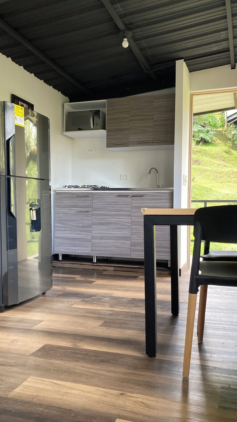 Kitchen with microwaves oven and fridge.