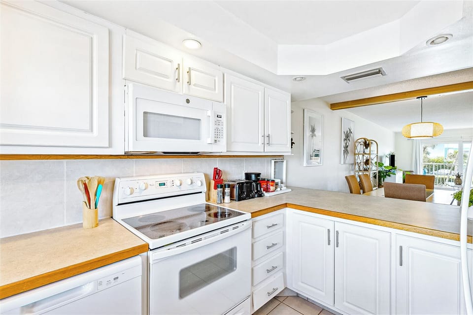 Charming white kitchen with modern appliances and a fresh inviting feel