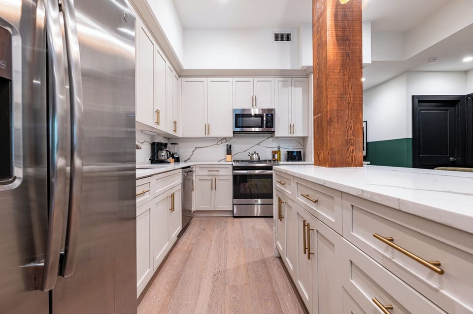 Cook or snack in style with a full kitchen featuring GE stainless appliances, cookware, and an island with bar seating. Ideal for short or extended stays, our kitchens make group travel in New Orleans easy and comfortable.