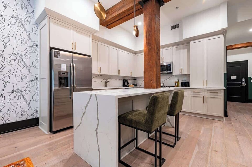 Cook or snack in style with a full kitchen featuring GE stainless appliances, cookware, and an island with bar seating. Ideal for short or extended stays, our kitchens make group travel in New Orleans easy and comfortable.