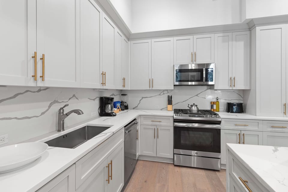 Cook or snack in style with a full kitchen featuring GE stainless appliances, cookware, and an island with bar seating. Ideal for short or extended stays, our kitchens make group travel in New Orleans easy and comfortable.