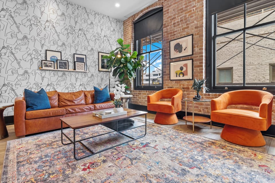 Relax in the living area with a smart TV, stylish seating, and a sleeper sofa for extra guests. Perfect for families or group stays in New Orleans, this inviting space is ideal for movie nights or recharging after a day in the city.