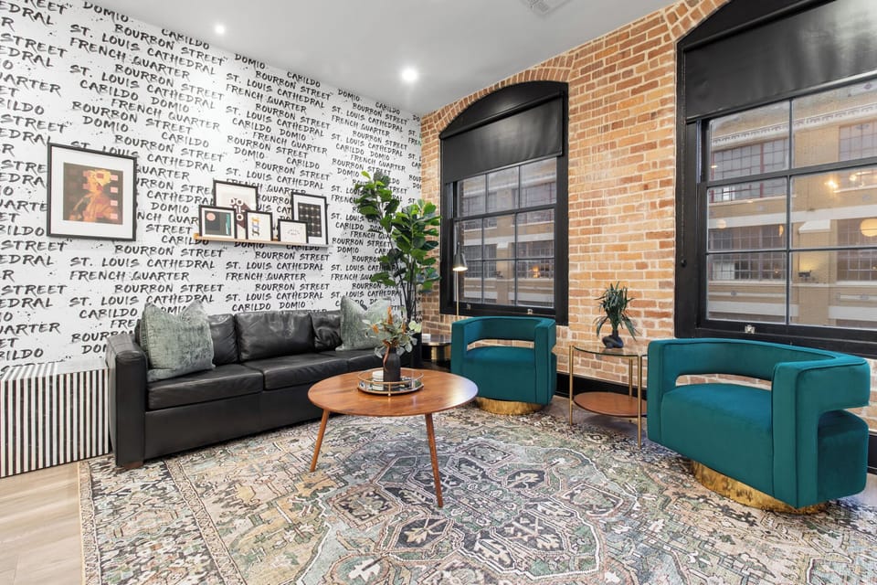 Relax in the living area with a smart TV, stylish seating, and a sleeper sofa for extra guests. Perfect for families or group stays in New Orleans, this inviting space is ideal for movie nights or recharging after a day in the city.