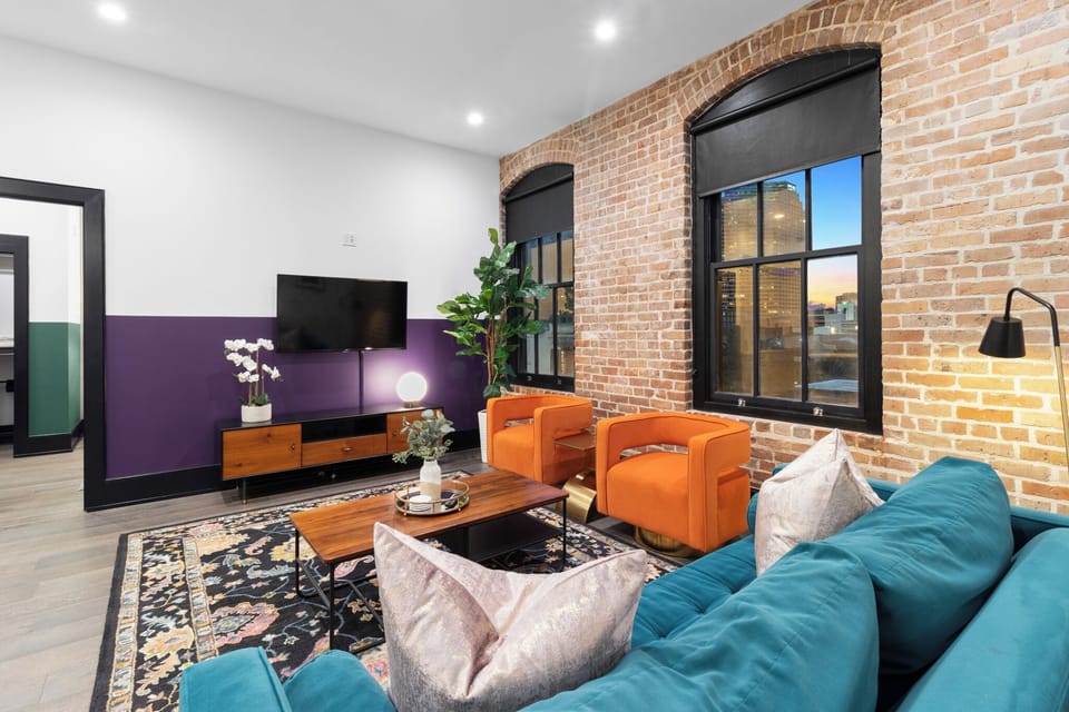Relax in the living area with a smart TV, stylish seating, and a sleeper sofa for extra guests. Perfect for families or group stays in New Orleans, this inviting space is ideal for movie nights or recharging after a day in the city.