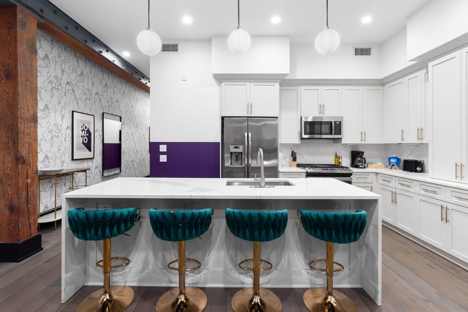 Cook or snack in style with a full kitchen featuring GE stainless appliances, cookware, and an island with bar seating. Ideal for short or extended stays, our kitchens make group travel in New Orleans easy and comfortable.