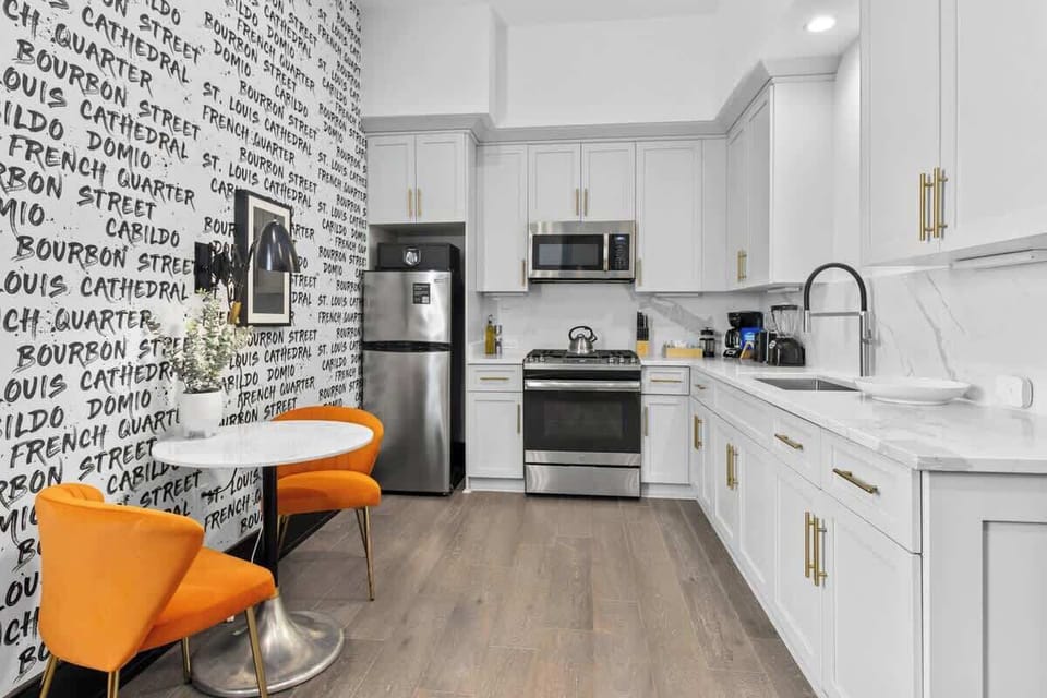 Cook or snack in style with a full kitchen featuring GE stainless appliances, cookware, and a dining table with two seating. Ideal for short or extended stays, our kitchens make group travel in New Orleans easy and comfortable.