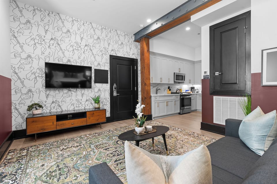 Relax in the living area with a smart TV, stylish seating, and a sleeper sofa for extra guests. Perfect for families or group stays in New Orleans, this inviting space is ideal for movie nights or recharging after a day in the city.