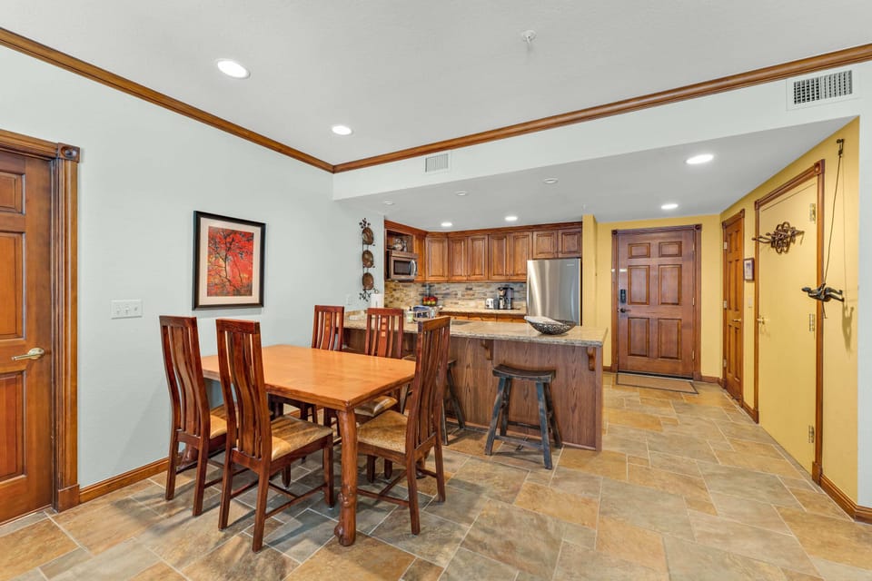 Dining Room: 5-person dining table, centrally located between kitchen and living room