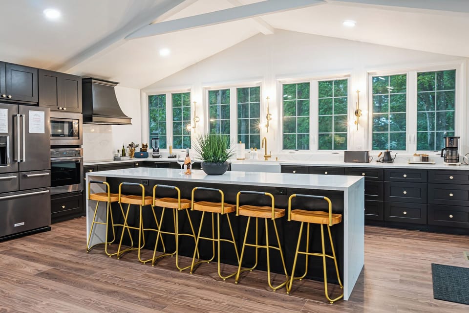 Waterfall countertops and gold accents in the kitchen