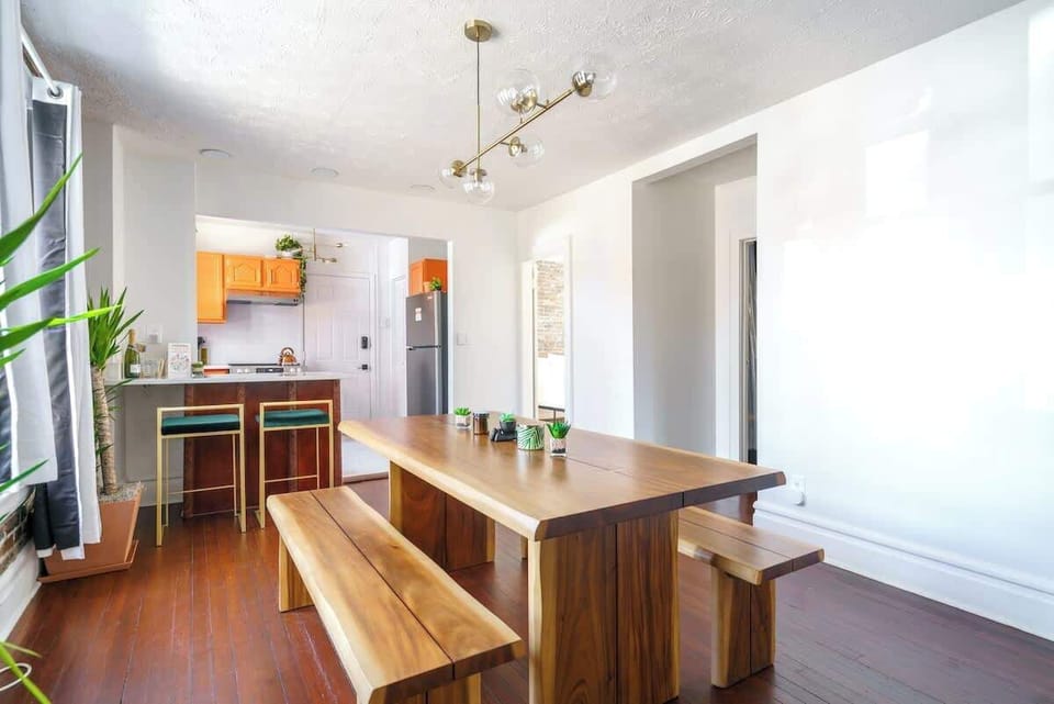 Enjoy unforgettable dining experiences in our kitchen, featuring a long dining table and a stylish kitchen island for both culinary creations and gourmet meals