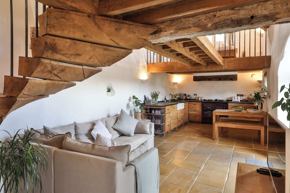 Large open plan kitchen diner with sandstone floor 