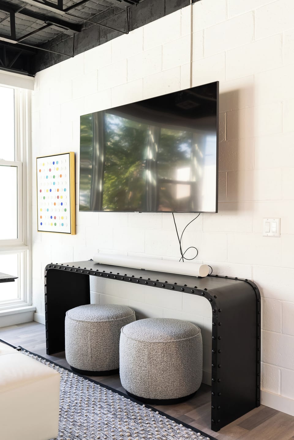 Wall-mounted TV with sleek setup, perfect for relaxing and streaming your favorite shows.