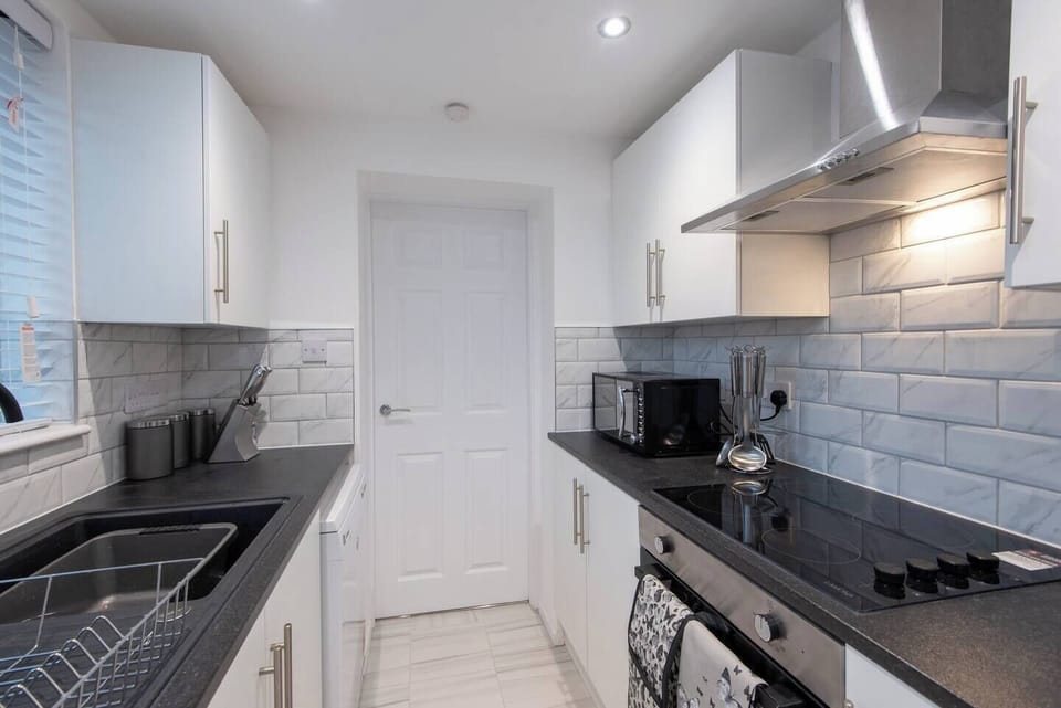 This kitchen space is  bathed in light that enhances its inviting ambiance. Safety is ensured with well-placed countertops and easy-to-reach cabinets.