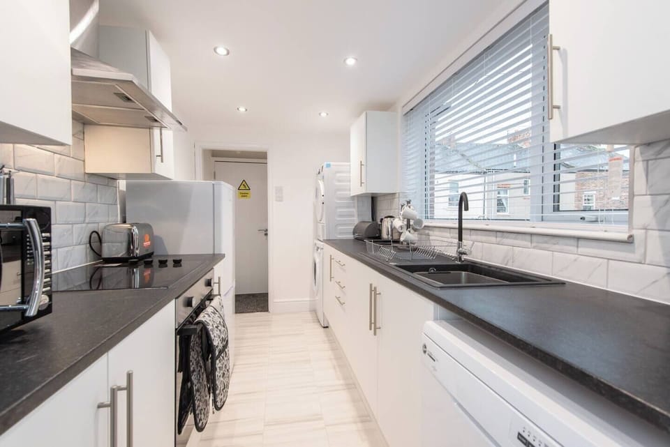 Enter our spacious kitchen, equipped with modern facilities to enhance your culinary experience.