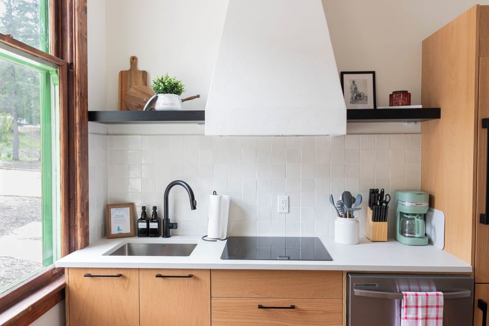 Enjoy the spacious kitchen setup with ample natural light streaming through the window.
