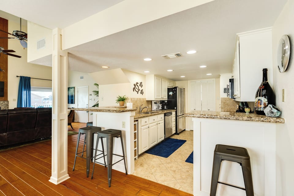 Nearby breakfast bar offers additional seating options