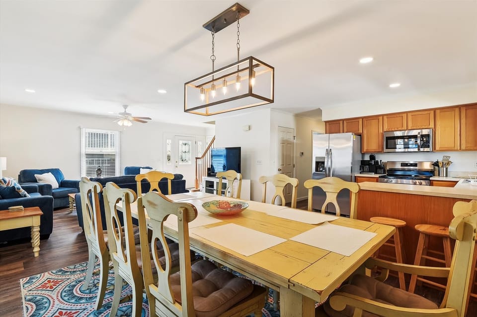 Gather everyone around this spacious dining table, where your group can share meals and make memories together in this bright, open-concept space.