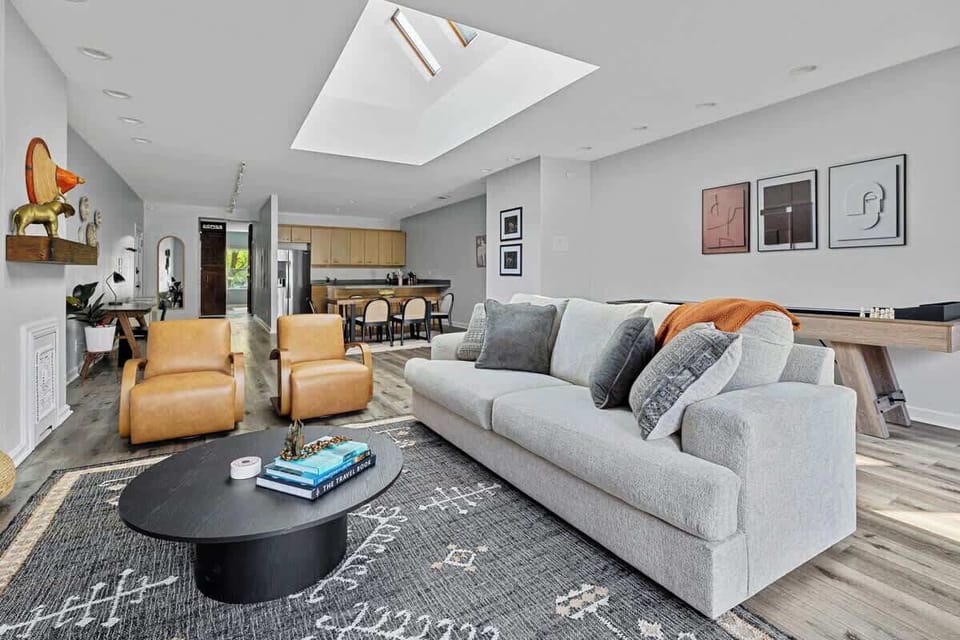 Basking in the natural glow of the skylight, cozied up on this comfy couch. Perfect spot for some quality 'me' time!