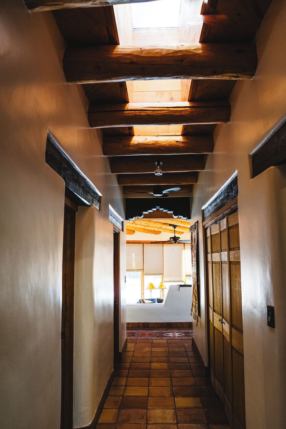 Exposed wooden beams and warm terracotta floors guide you toward your bright, welcoming kitchen space.