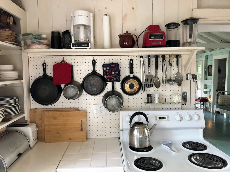 Classic peg board storage for pots and pans.