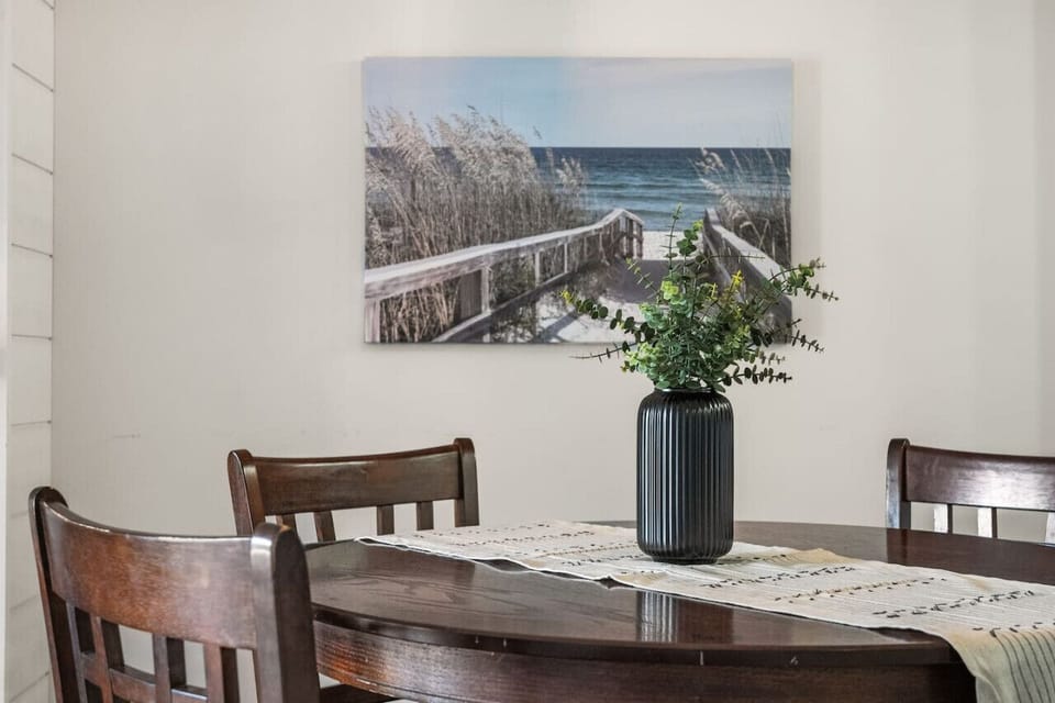 Dining area with table seating for 4 and 2 on the island.